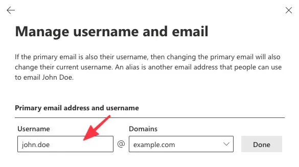 Manage username and email dialog showing username and domain fields with a red arrow pointing at the username input.
