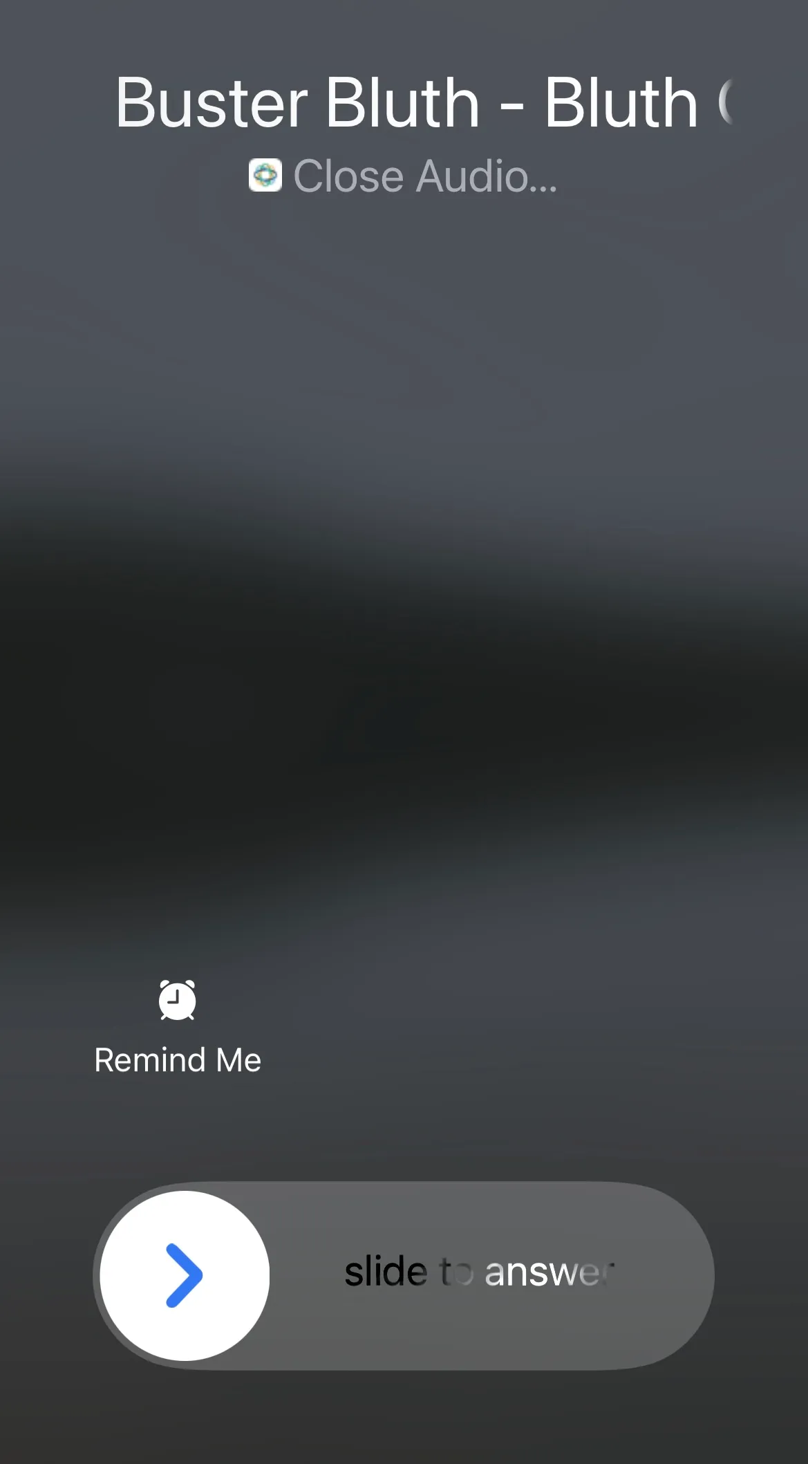 iPhone incoming call screen showing caller name Buster Bluth with Close Audio and slide to answer control.